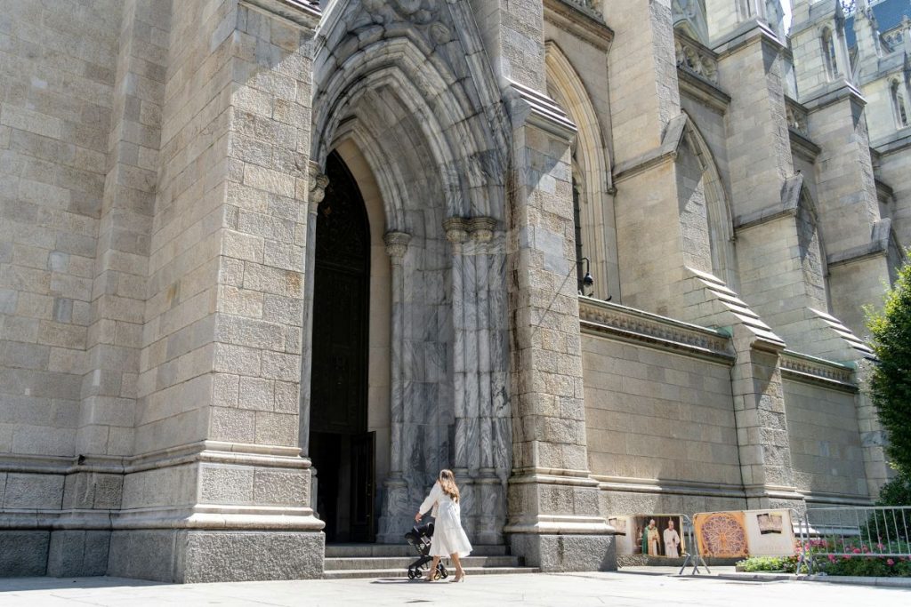 A woman walking into a church. 