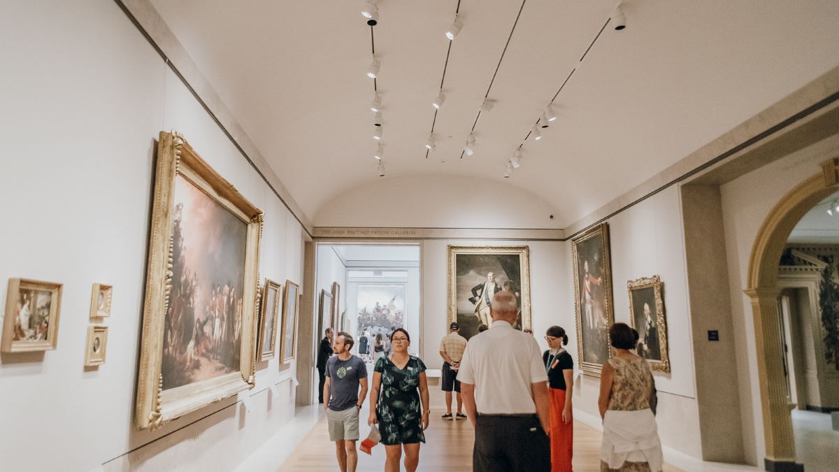 people walking through large museum