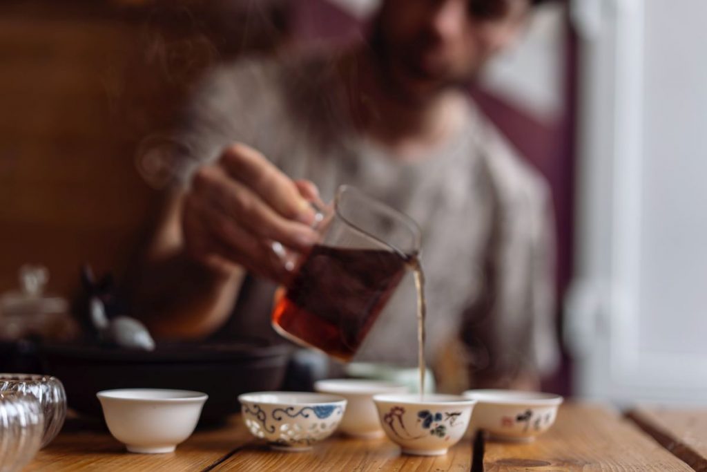 Chinese tea being poured into teacups.