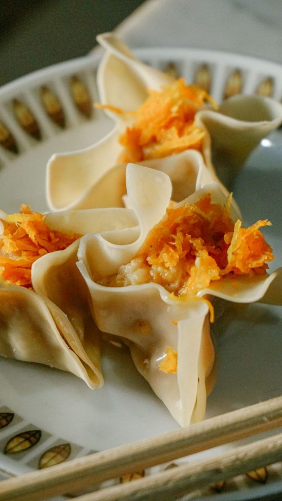 A plate of dim sum dumplings with a chicken filling.