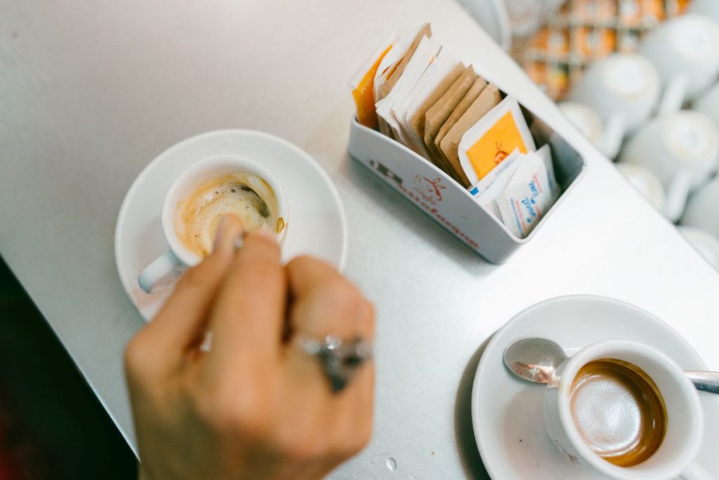 A woman stirring espresso at the H'ART museum in Amsterdam. 