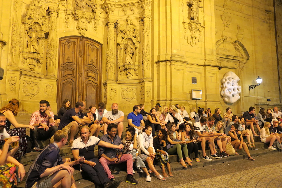 People sitting outside in San Sebastián