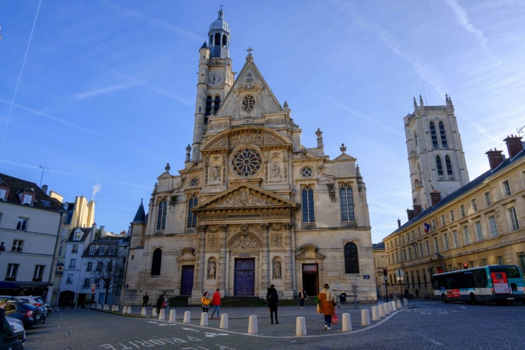 People walking outside of Saint Étienne du Mont in Paris, one of the most famous churches in Paris.