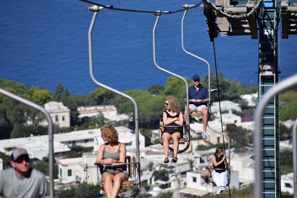People riding the Monte Solaro Chairlift in Capri, Italy. 