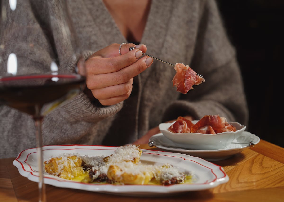 Woman dining Italian food with red wine, restaurants in Ischia