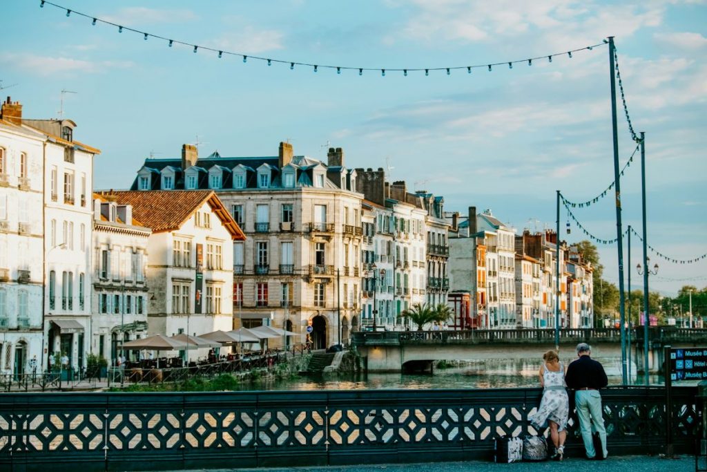 A couple looking at Bayonne from a bridge. 