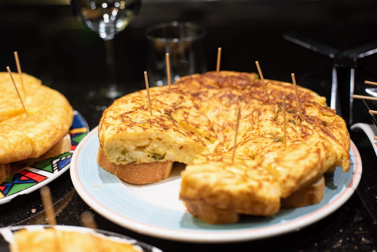 Large round omelette sitting on toast with toothpicks