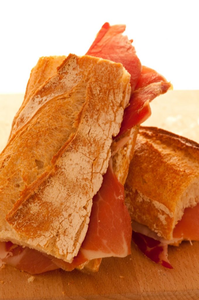 A jamon sandwich with baguette bread. 