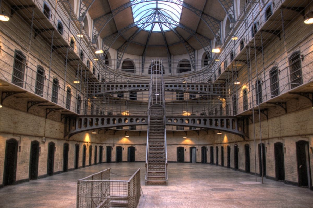 large prison interior with bars on each level.