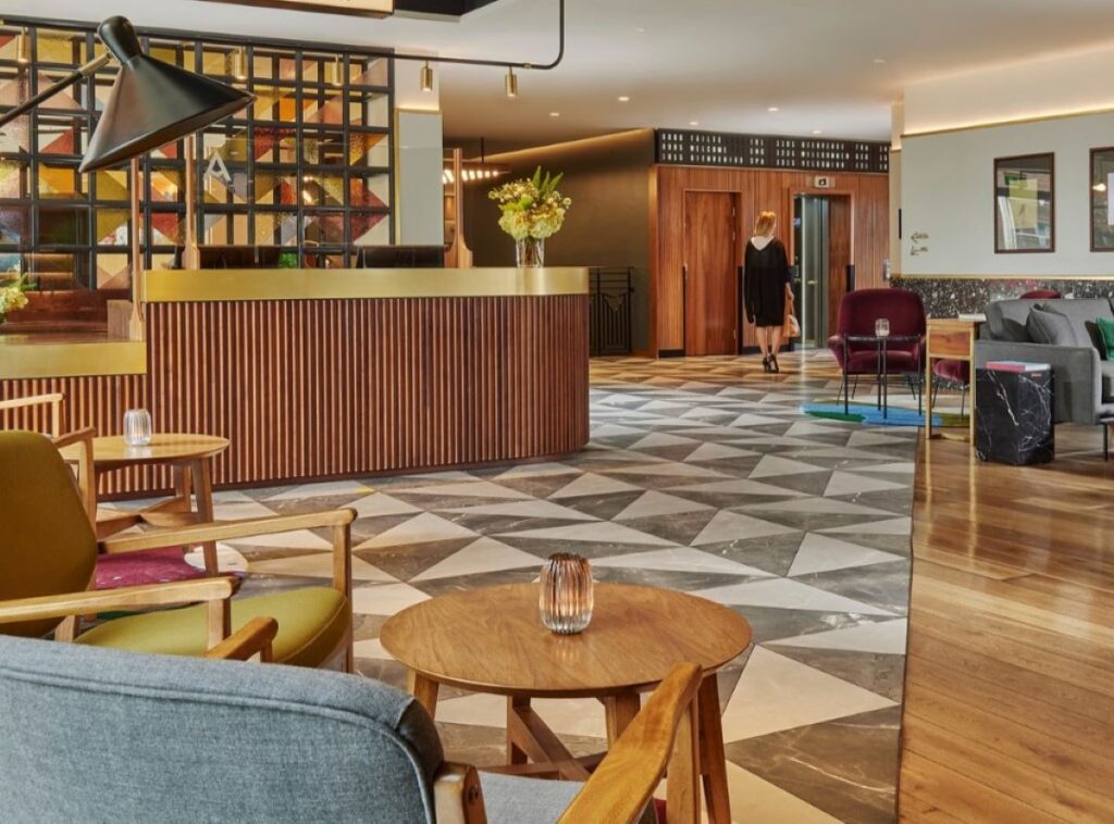 Hotel lobby with large seating area and triangular-tiled floor