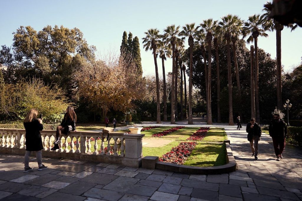 People taking photos and walking around the National Garden in Athens, Greece. 