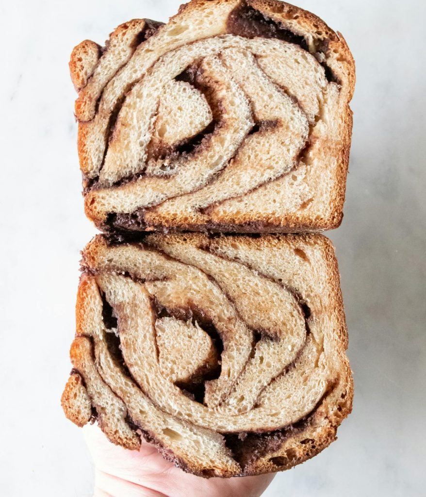 A person holding two slices of babka. 