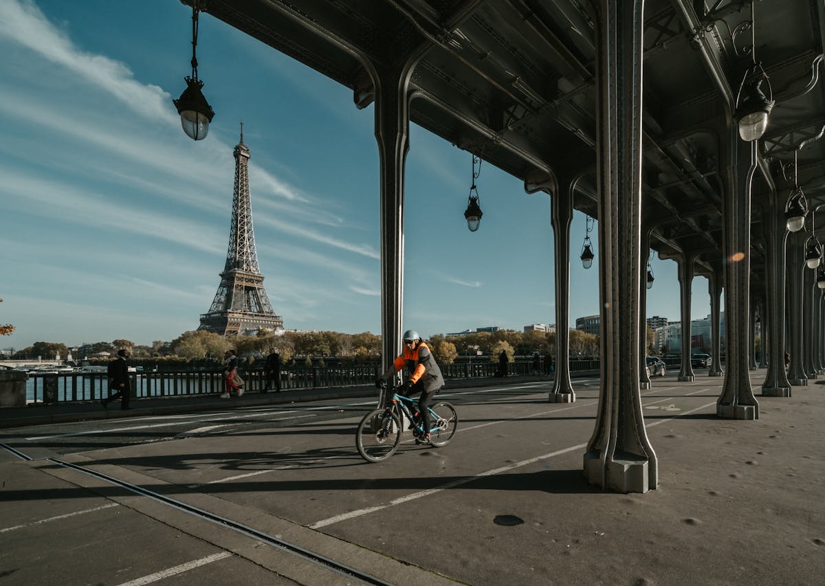 Man riding a bike with Eiffel Tower in background