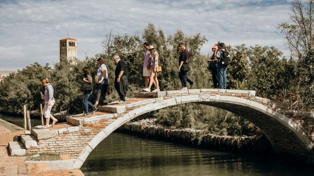 People walking over a bride at the Venetian Islands.