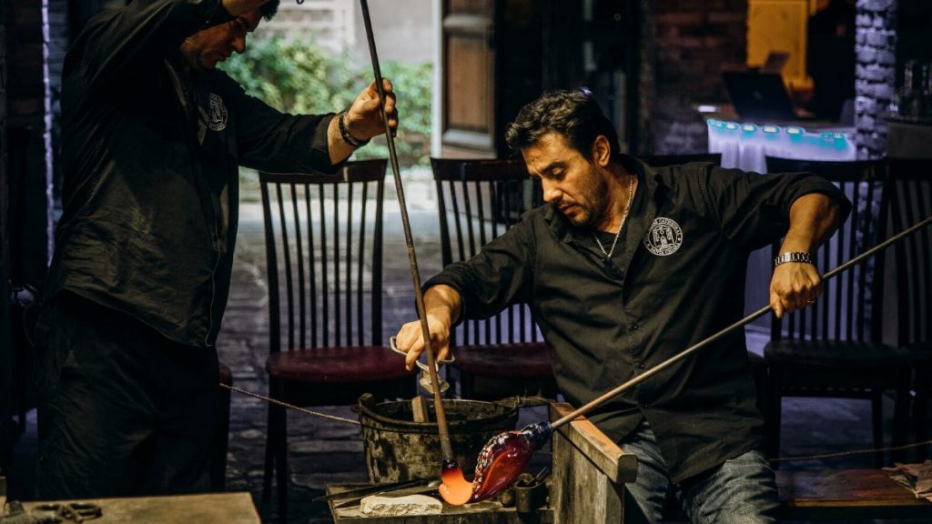 A glass blower at Murano Island demonstrating glass making.