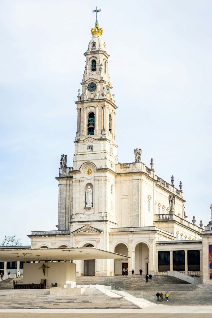 People walking into 
Sanctuary of Our Lady of Fátima in Fátima, Portugal. 