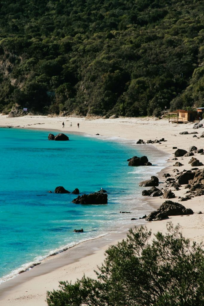 People walking on the beach in Arrábida, Portugal. 