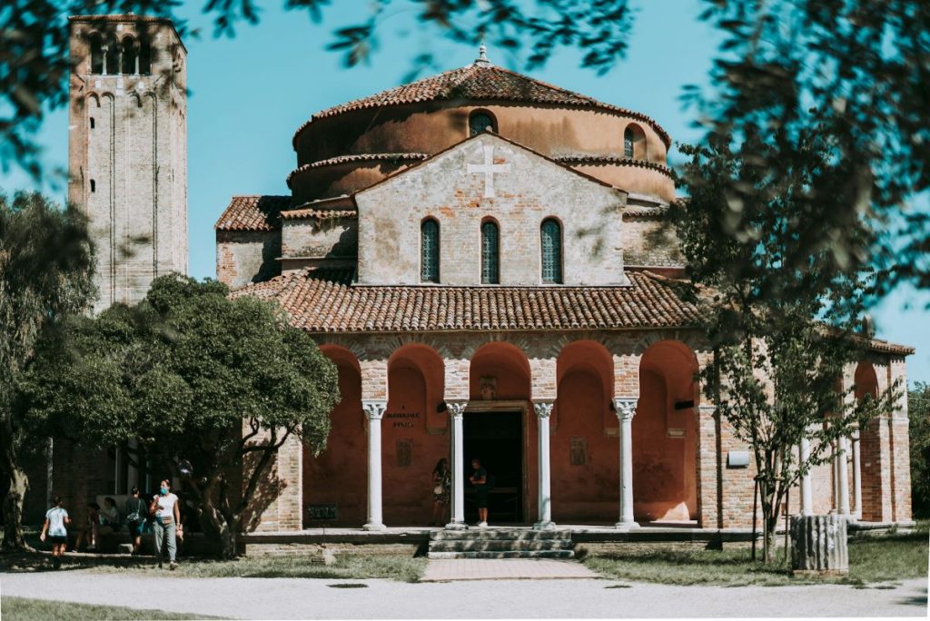 People walking outside of Cathedral of Santa Maria Assunta. 