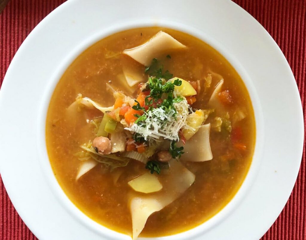 bowl of brown soup with vegetables