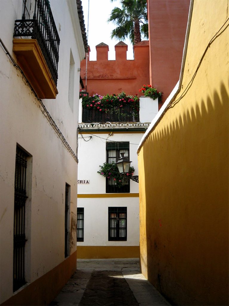 narrow street with white and yellow walls