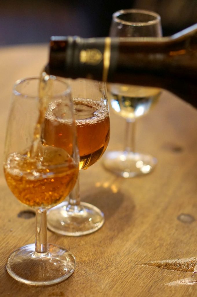 Glasses of sherry being poured. 