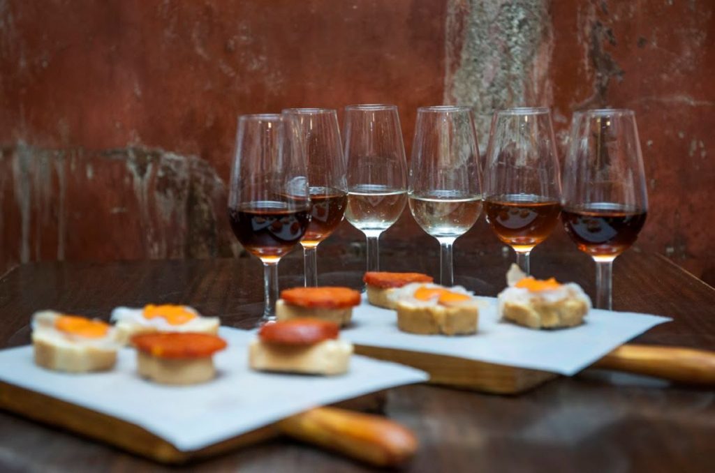 Six glasses of sherry wine on a table with tapas for a sherry tasting in Jerez.