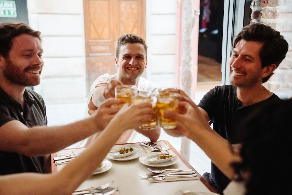 People toasting at a bar