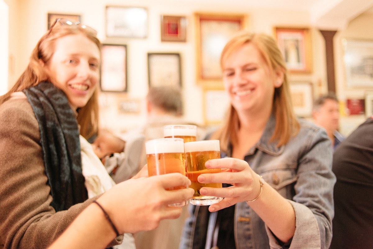 women toasting with beers