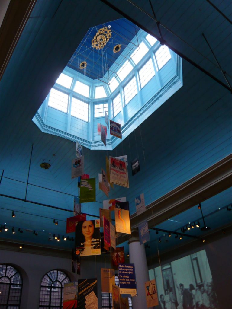 A vertical exhibit hanging from the ceiling in the Jewish Historical Museum. 