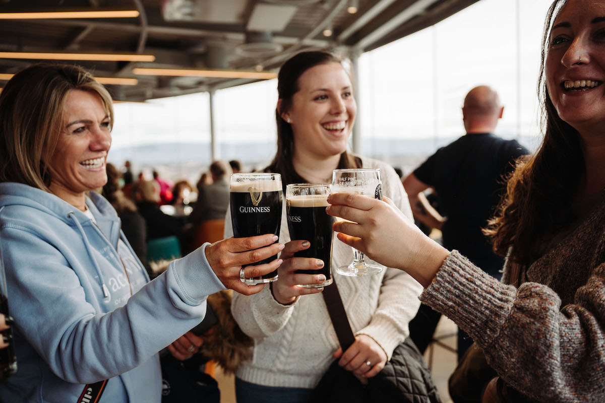 People having fun and toasting with a Guinness beer