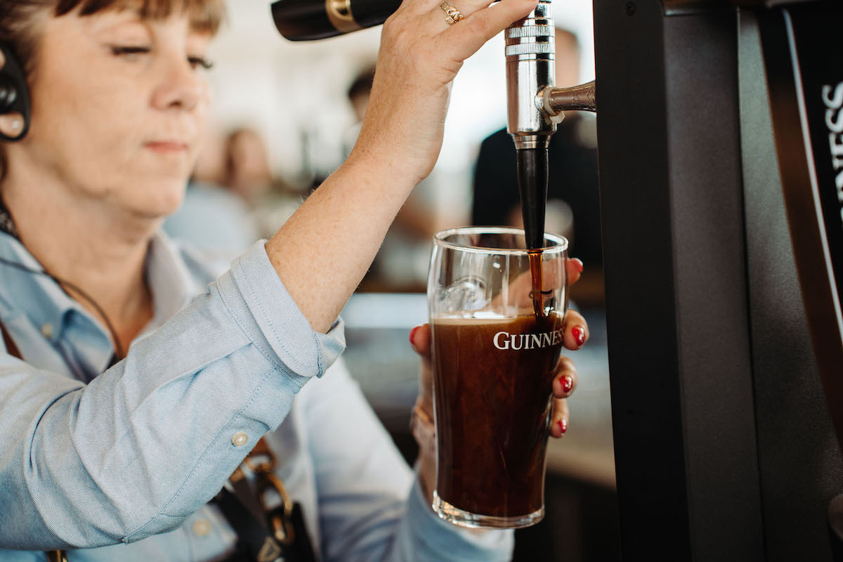 Waiter pouring a pint of beer Guinness