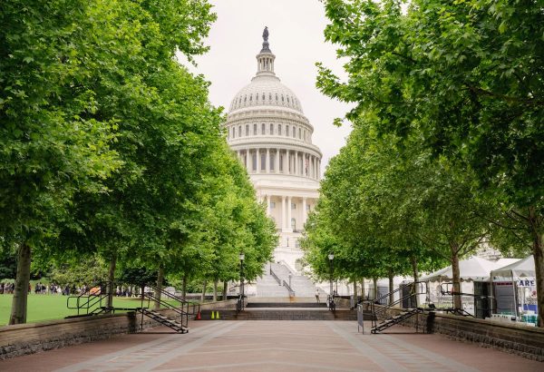 a walkway leading up to a large domed building