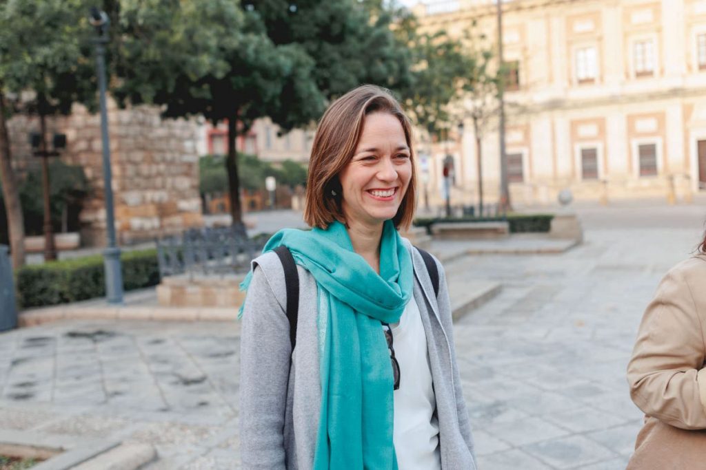 A woman standing outside the cathedral in Seville. 