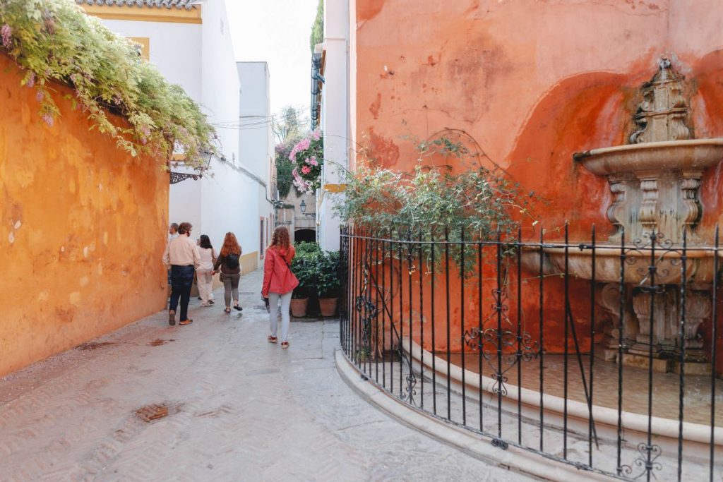 A group of people walking down street in Seville. 