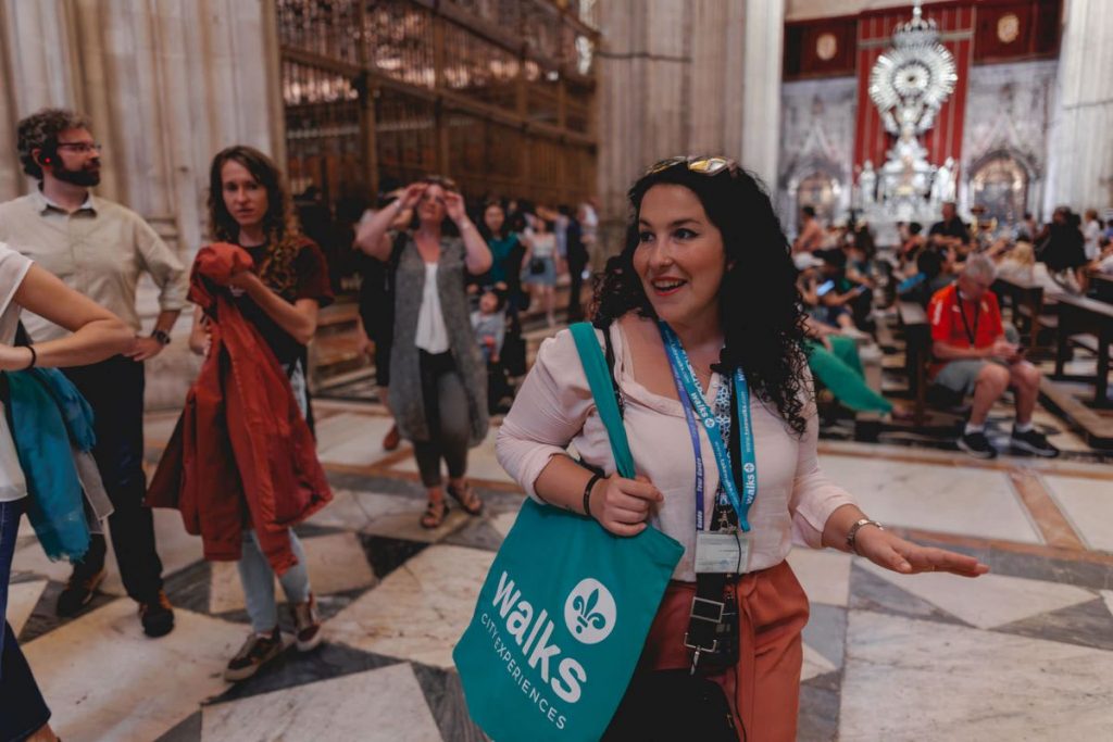 A group of people exploring the Seville cathedral. 