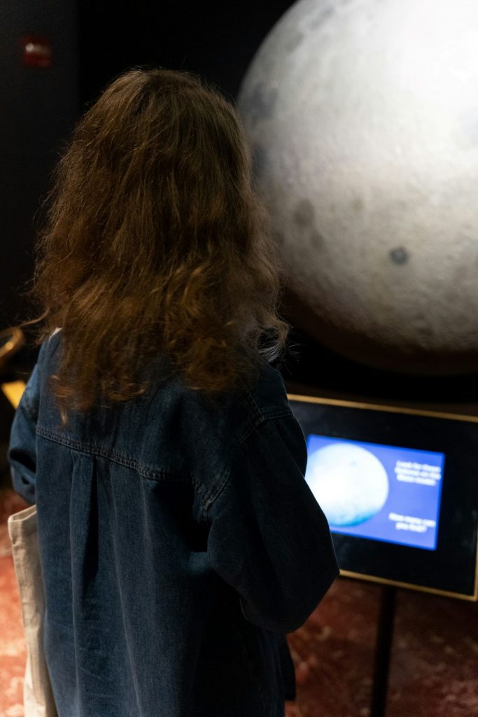 A little girl at a planetarium. 