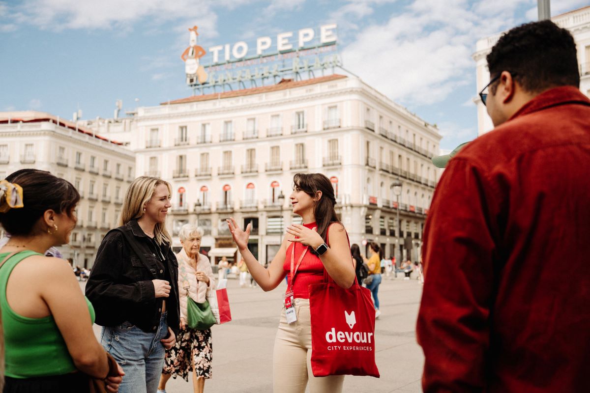 woman talking to group of people in large square