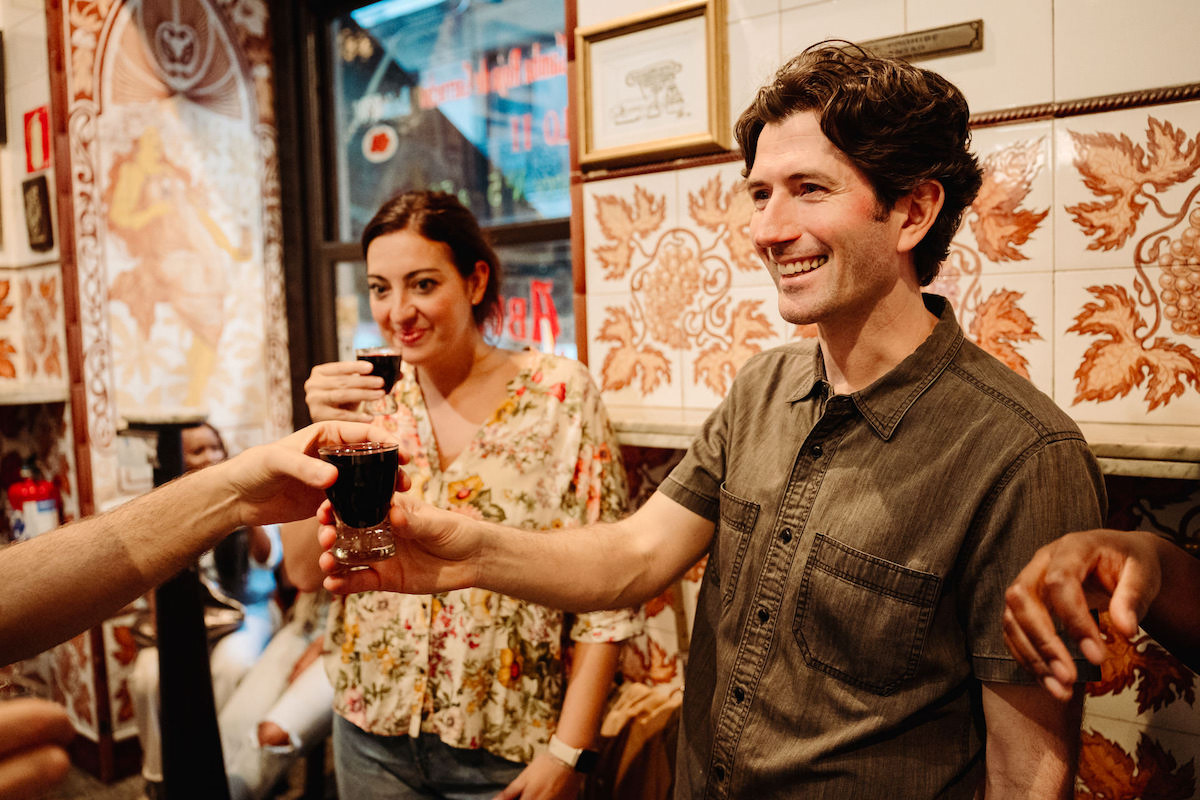 People enjoying a glass of red wine in a typical bar in Madrid