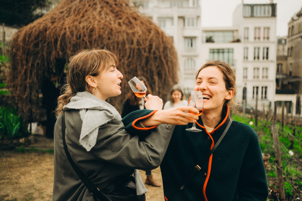 Group drinking wine and having fun in Paris with tour