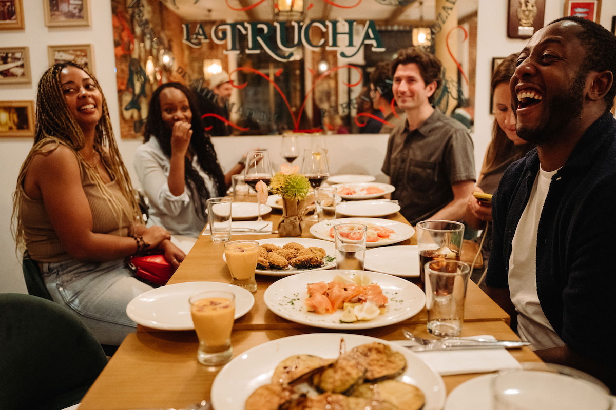 Group laughing and eating tapas in Madrid