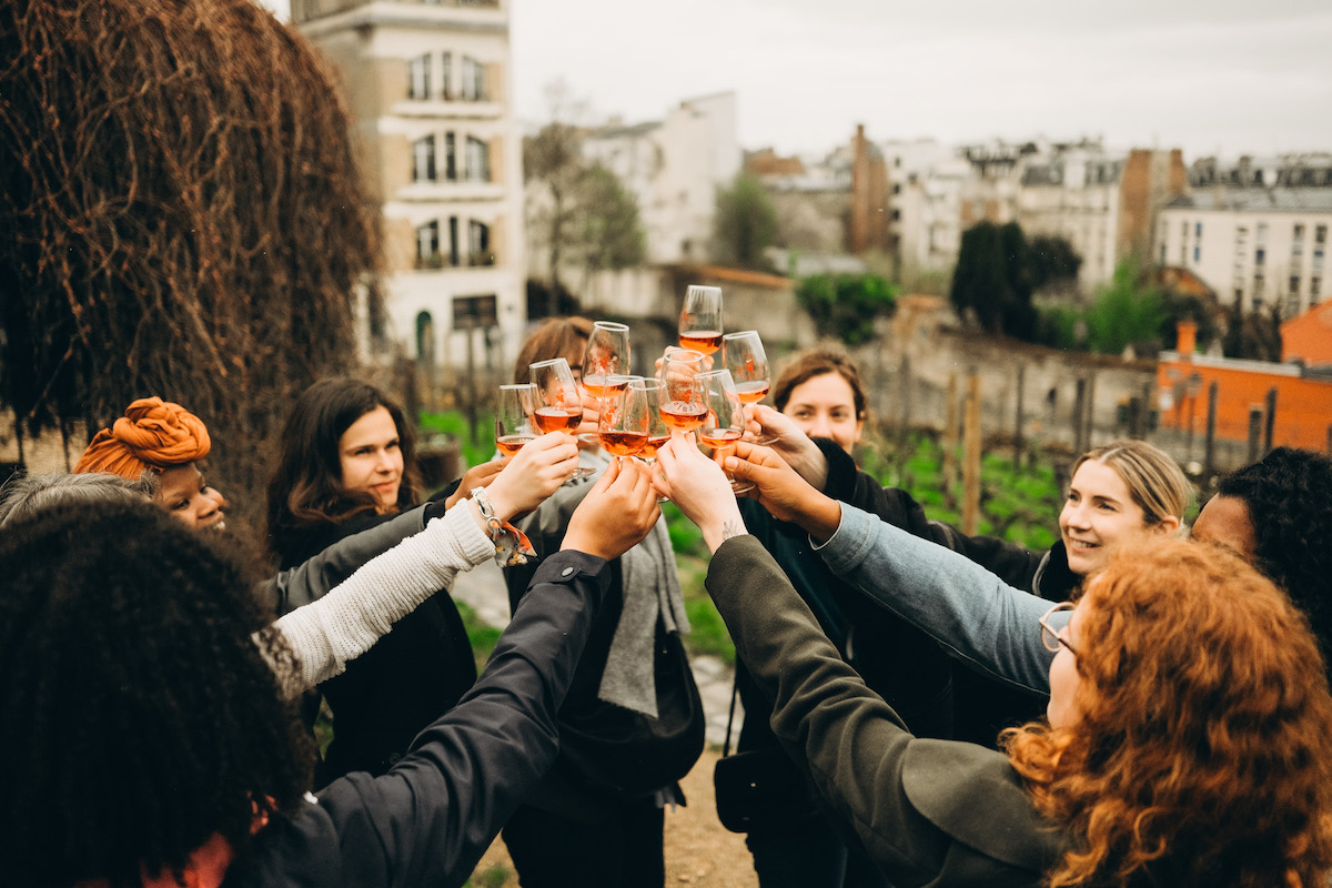 Group toasting with glass of wine in Montmartre, Paris