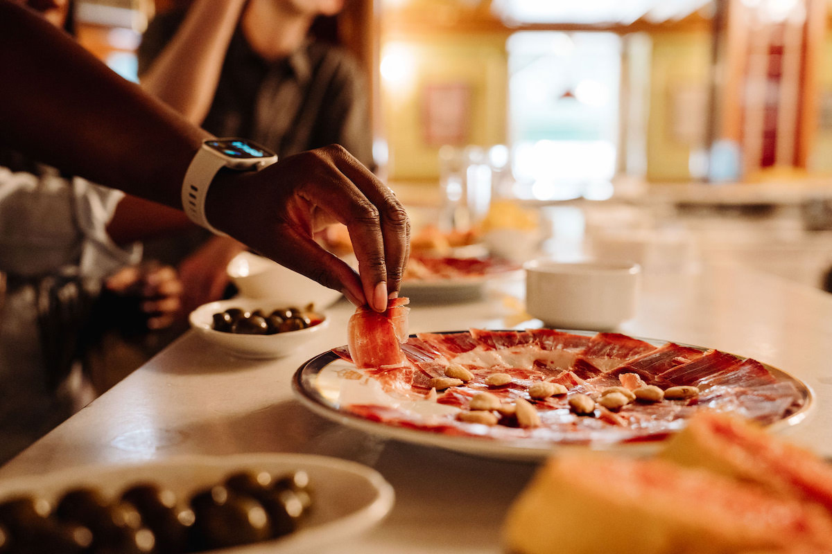 Hand taking some Spanish Ham from a ración