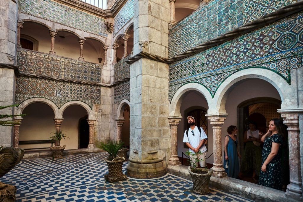 A man looking at the interior of a palace.