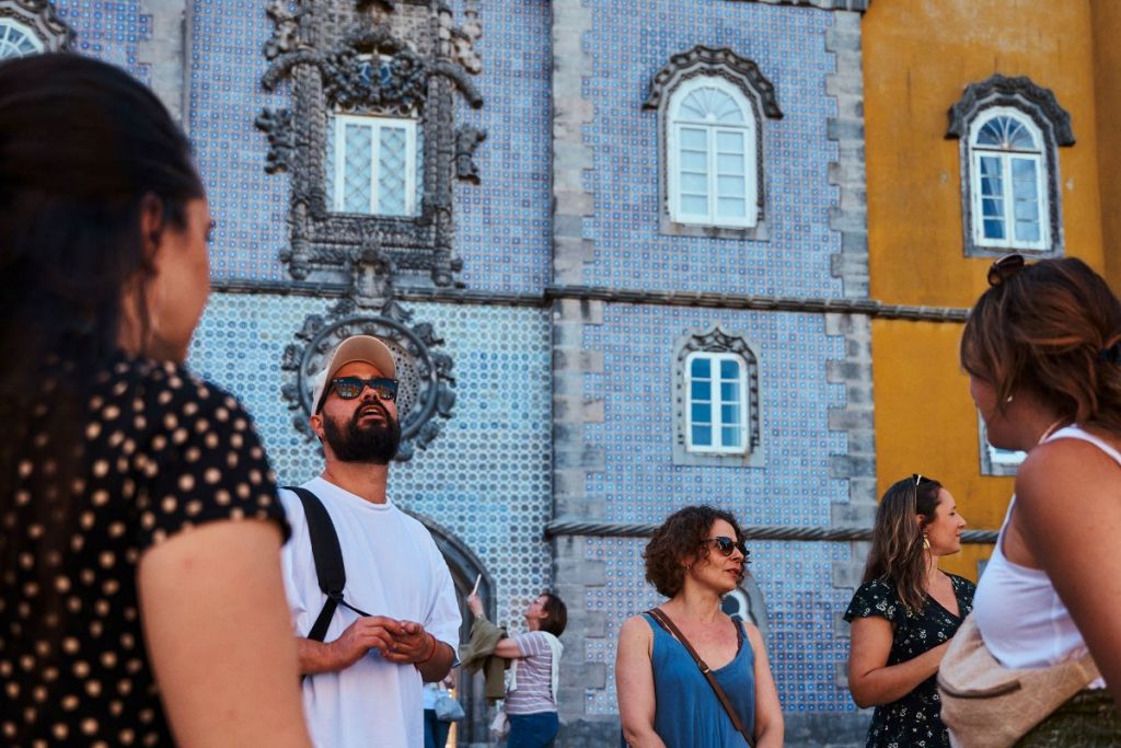 People admiring the exterior of Pena Palace. 