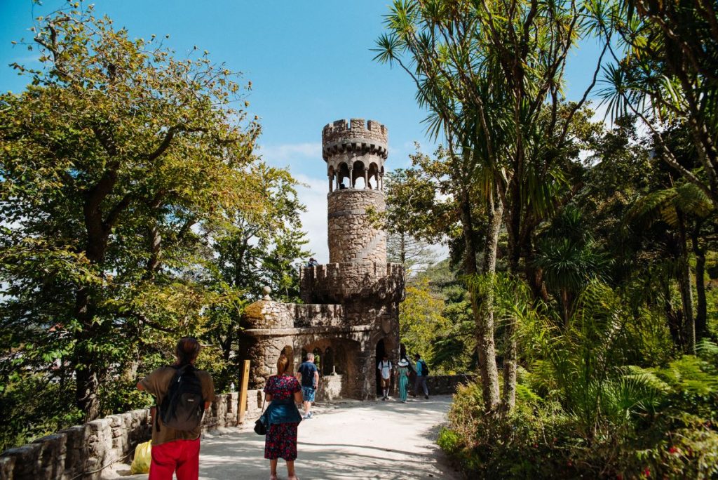 People walking around the grounds outside of Pena Palace.