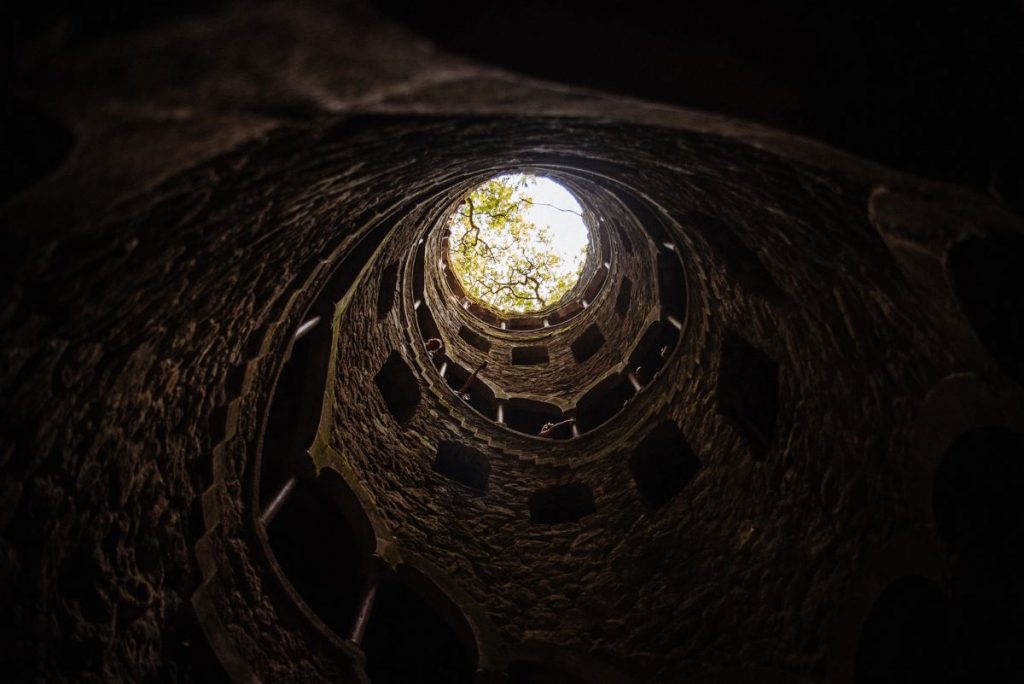 Someone looking up the Quinta da Regaleira Intention Well.