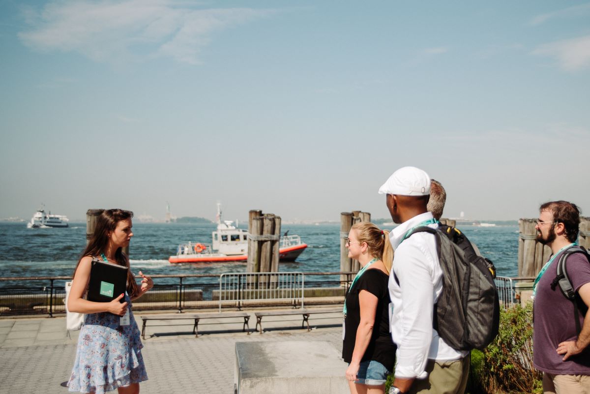 People standing at the waterfront at Battery Park.