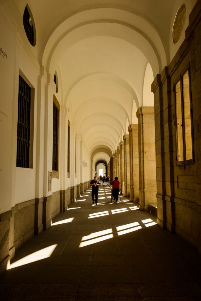 People walking down the corridors at a museum. 