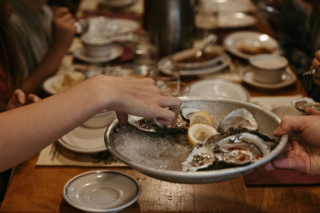 People eating oyster at one of the haunted places in Salem.