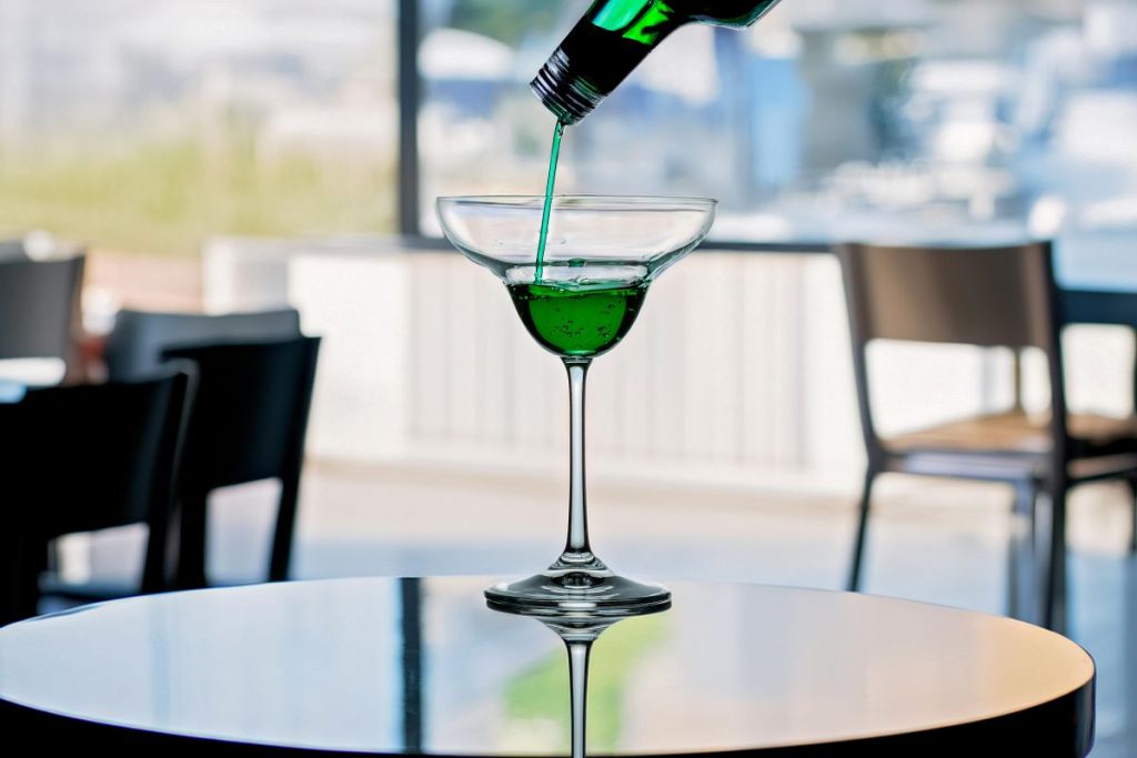 A bartender pouring Absinthe at one of the Barcelona literary haunts. 